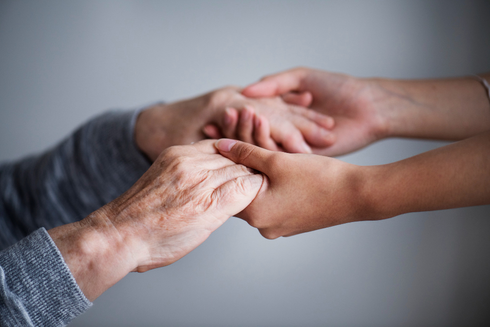 mani che aiutano una persona affetta da alzheimer